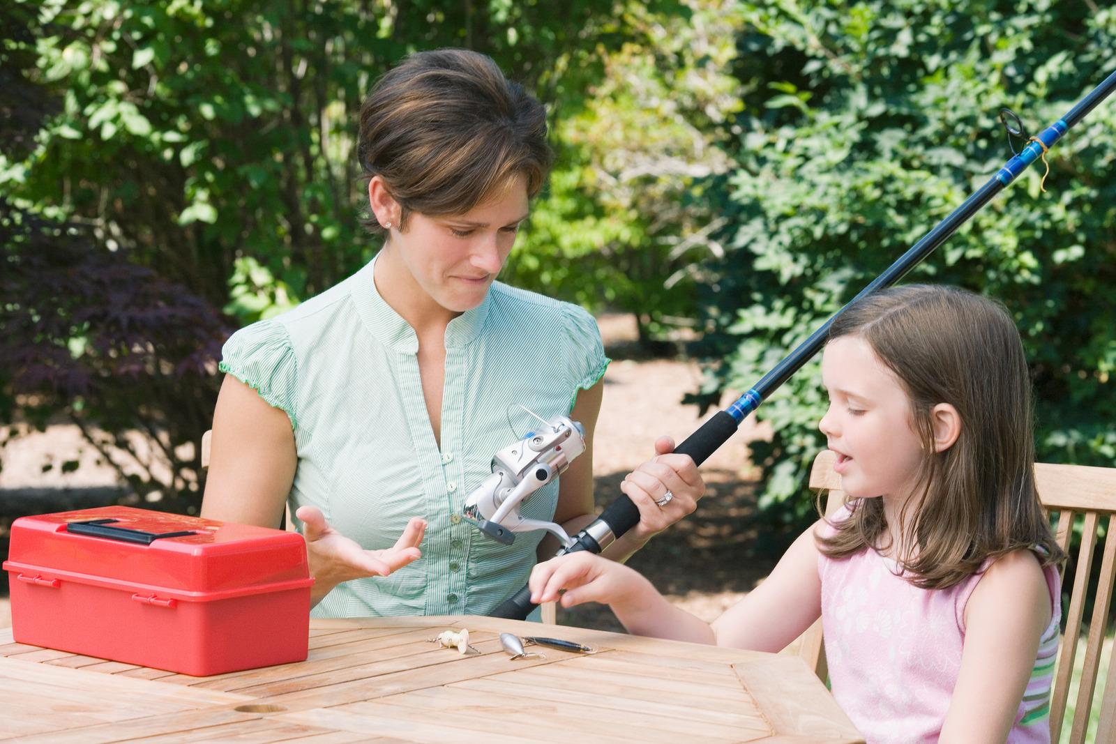 Mother and daughter assembling fishing rod
