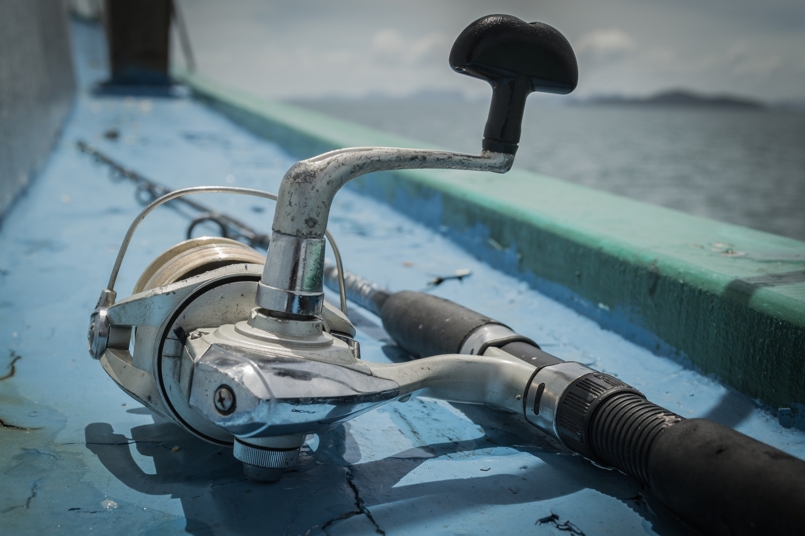old fishing rod on the boat under sunlight